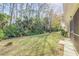 Spacious backyard with lush landscaping and natural wooded area at 2853 Turnbull Estates Dr, New Smyrna Beach, FL 32168