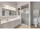 Bathroom with shower, vanity, and white cabinets at 2853 Turnbull Estates Dr, New Smyrna Beach, FL 32168