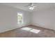 Bright bedroom with ceiling fan, carpet flooring, and large window at 2853 Turnbull Estates Dr, New Smyrna Beach, FL 32168