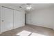 Well-lit bedroom with ceiling fan, carpet flooring, and closet at 2853 Turnbull Estates Dr, New Smyrna Beach, FL 32168