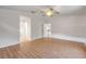 Large bedroom with wood-look flooring and access to bathroom at 2853 Turnbull Estates Dr, New Smyrna Beach, FL 32168