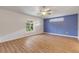 Spacious bedroom with wood-look floors and blue accent wall at 2853 Turnbull Estates Dr, New Smyrna Beach, FL 32168