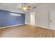 Bright bedroom with wood-look floors and blue accent wall at 2853 Turnbull Estates Dr, New Smyrna Beach, FL 32168