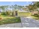 House exterior showcasing a well-maintained lawn and driveway at 2853 Turnbull Estates Dr, New Smyrna Beach, FL 32168