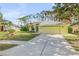 Front view of a yellow house with a driveway and landscaping at 2853 Turnbull Estates Dr, New Smyrna Beach, FL 32168