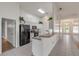 Modern kitchen with white cabinets and black appliances at 2853 Turnbull Estates Dr, New Smyrna Beach, FL 32168