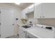 Clean laundry room with washer, dryer, and cabinets at 2853 Turnbull Estates Dr, New Smyrna Beach, FL 32168