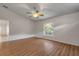 Bright living room with vaulted ceiling, wood-look flooring, and large window at 2853 Turnbull Estates Dr, New Smyrna Beach, FL 32168