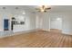 Open concept living room with kitchen view and wood floors at 2853 Turnbull Estates Dr, New Smyrna Beach, FL 32168