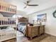 Bedroom with bunk beds, dresser, and coastal-themed decor at 3145 S Atlantic Ave # 201, Daytona Beach Shores, FL 32118