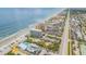 Wide aerial view of beachfront property and coastline at 3501 S Atlantic Ave # 407, New Smyrna Beach, FL 32169