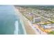 Expansive aerial view of the building and beach at 3501 S Atlantic Ave # 407, New Smyrna Beach, FL 32169
