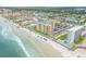 Aerial view of beachfront property with ocean, building, and parking at 3501 S Atlantic Ave # 407, New Smyrna Beach, FL 32169