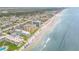 Aerial view showing oceanfront building and beach access at 3501 S Atlantic Ave # 407, New Smyrna Beach, FL 32169