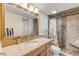 Bathroom with granite countertop, walk-in shower, and updated fixtures at 3501 S Atlantic Ave # 407, New Smyrna Beach, FL 32169