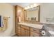 Updated bathroom with granite vanity and a large mirror at 3501 S Atlantic Ave # 407, New Smyrna Beach, FL 32169