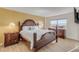 Spacious bedroom with a king-size bed and wood furniture at 3501 S Atlantic Ave # 407, New Smyrna Beach, FL 32169