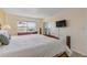 Bedroom with king-size bed, dresser, and access to balcony at 3501 S Atlantic Ave # 407, New Smyrna Beach, FL 32169