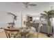 Dining area with glass table, four chairs and view of living room at 3501 S Atlantic Ave # 407, New Smyrna Beach, FL 32169