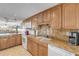 Kitchen boasts granite countertops, wood cabinets, and modern appliances at 3501 S Atlantic Ave # 407, New Smyrna Beach, FL 32169