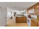 Open kitchen with island, granite counters, and wood cabinets at 3501 S Atlantic Ave # 407, New Smyrna Beach, FL 32169