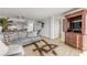 Spacious living room, gray sectional sofa, and access to other rooms at 3501 S Atlantic Ave # 407, New Smyrna Beach, FL 32169