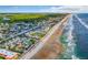 Aerial view of the coastline and surrounding buildings at 3509 S Atlantic Ave # 108 & 109, New Smyrna Beach, FL 32169