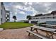 Outdoor picnic area with grills and patio tables at 3509 S Atlantic Ave # 108 & 109, New Smyrna Beach, FL 32169