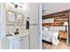 Small bathroom with vanity and view into bedroom at 3509 S Atlantic Ave # 108 & 109, New Smyrna Beach, FL 32169