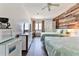 Two beds, dresser, and kitchenette in bedroom at 3509 S Atlantic Ave # 108 & 109, New Smyrna Beach, FL 32169