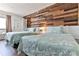 Two beds with a wood accent wall at 3509 S Atlantic Ave # 108 & 109, New Smyrna Beach, FL 32169
