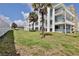 Side view of the building showing landscaping and a hammock at 3509 S Atlantic Ave # 108 & 109, New Smyrna Beach, FL 32169