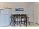 Bright eat-in kitchen with white cabinets and a table for four at 3509 S Atlantic Ave # 108 & 109, New Smyrna Beach, FL 32169