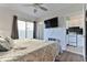 Main bedroom with king bed, TV, and kitchenette view at 3509 S Atlantic Ave # 108 & 109, New Smyrna Beach, FL 32169