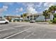 Exterior view of the building, parking lot, and landscaping at 3509 S Atlantic Ave # 108 & 109, New Smyrna Beach, FL 32169