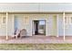 Brick patio with two pink chairs, leading to glass sliding doors at 3509 S Atlantic Ave # 108 & 109, New Smyrna Beach, FL 32169