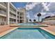 Community pool and spa with surrounding patio and lounge chairs at 3509 S Atlantic Ave # 108 & 109, New Smyrna Beach, FL 32169