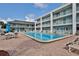 Community pool with patio furniture and surrounding landscaping at 3509 S Atlantic Ave # 108 & 109, New Smyrna Beach, FL 32169