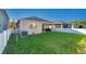 Large backyard with a grassy area and white fence at 355 Caryota Ct, New Smyrna Beach, FL 32168