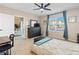 Well-lit bedroom with a view, large dresser, and a home office setup at 355 Caryota Ct, New Smyrna Beach, FL 32168