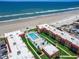 Aerial view of beachfront property with pool and ocean access at 3801 S Atlantic Ave # Ut104, New Smyrna Beach, FL 32169