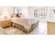 Cozy bedroom with a plaid bedspread and tiled floor at 3801 S Atlantic Ave # Ut104, New Smyrna Beach, FL 32169