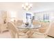Bright dining area with glass-top table and wicker chairs, near living room at 3801 S Atlantic Ave # Ut104, New Smyrna Beach, FL 32169