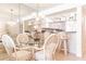 Dining area with glass-top table and wicker chairs, kitchen bar view at 3801 S Atlantic Ave # Ut104, New Smyrna Beach, FL 32169