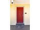 Red front door to condo unit with a welcome mat at 3801 S Atlantic Ave # Ut104, New Smyrna Beach, FL 32169