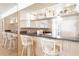 Kitchen with white cabinets, granite counters and bar seating at 3801 S Atlantic Ave # Ut104, New Smyrna Beach, FL 32169