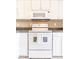 White kitchen appliances and granite countertop at 3801 S Atlantic Ave # Ut104, New Smyrna Beach, FL 32169