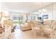 Bright living room with seating area and dining space, offering pool and partial ocean views at 3801 S Atlantic Ave # Ut104, New Smyrna Beach, FL 32169