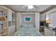 Bright bedroom with built-in shelving, Murphy bed, and a workspace at 4139 Atlantic # A406, New Smyrna Beach, FL 32169