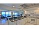 Modern kitchen with white cabinets and wood accent ceiling at 4139 Atlantic # A406, New Smyrna Beach, FL 32169